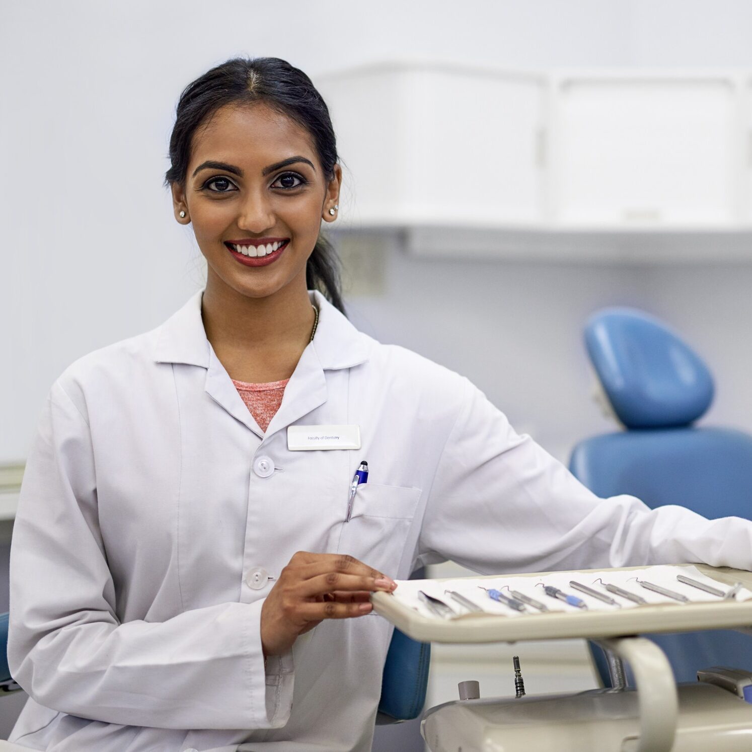 oral-health-is-essential-part-healthy-life-portrait-young-female-dentist-sitting-alongside-tray-surgical-instruments-her-office (1)